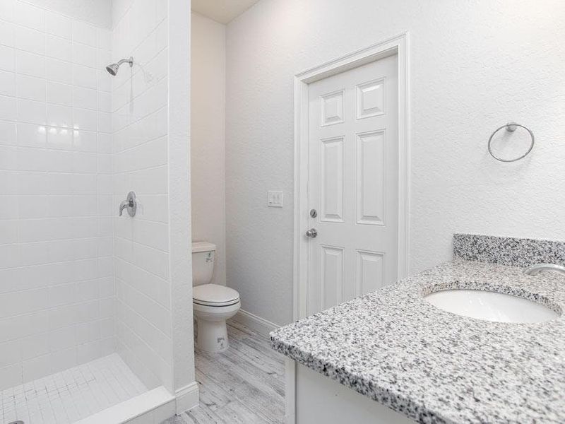 The in-law suite has en-suite access to Bath 3, and a pool door to the lanai - Willow II by Highland Homes The in-law suite has en-suite access to Bath 3, and a pool door to the lanai - Willow II by Highland Homes