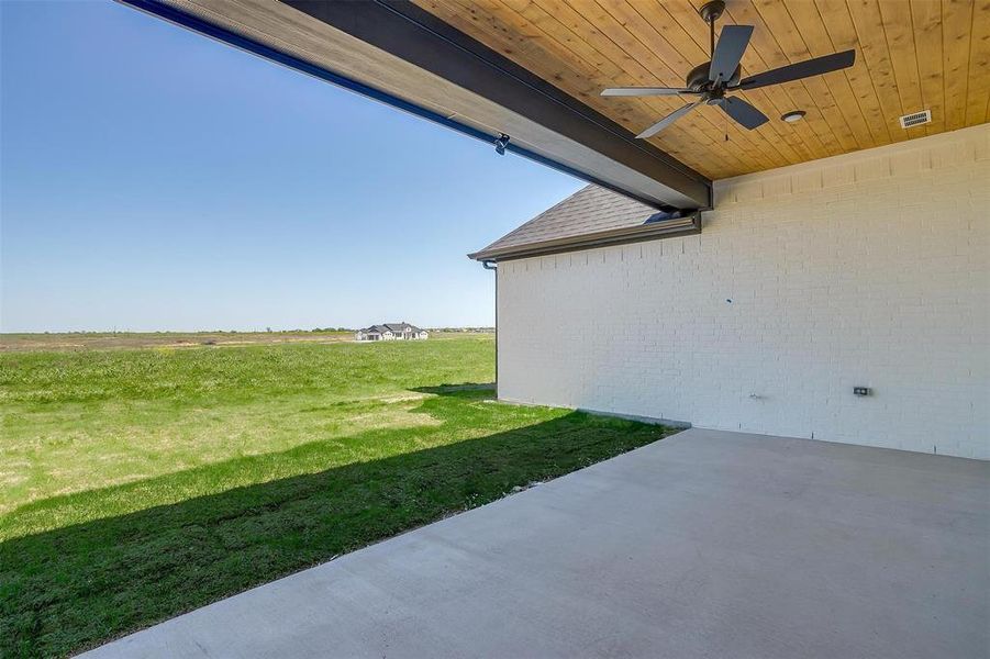 View of yard with a patio area, visible vents, and a ceiling fan View of yard with a patio area, visible vents, and a ceiling fan