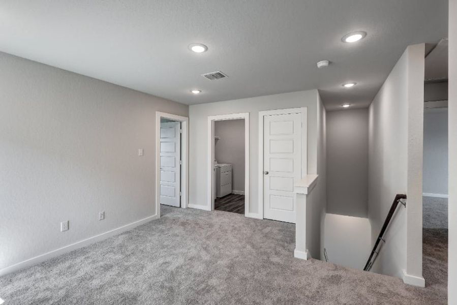 A hallway with white doors. A hallway with white doors.