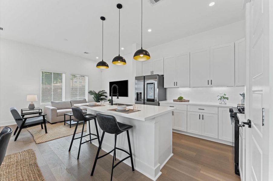 This centrally positioned kitchen island serves as a stylish anchor within the open-concept layout, offering clear sightlines to the dining area, living space, and the front yard. Its placement encourages seamless interaction, whether prepping meals or entertaining guests, while natural light pours in through the nearby windows. The island’s sleek design and functional surface make it a hub of activity, framed by elegant finishes tying together comfort and sophistication. This centrally positioned kitchen island serves as a stylish anchor within the open-concept layout, offering clear sightlines to the dining area, living space, and the front yard. Its placement encourages seamless interaction, whether prepping meals or entertaining guests, while natural light pours in through the nearby windows. The island’s sleek design and functional surface make it a hub of activity, framed by elegant finishes tying together comfort and sophistication.