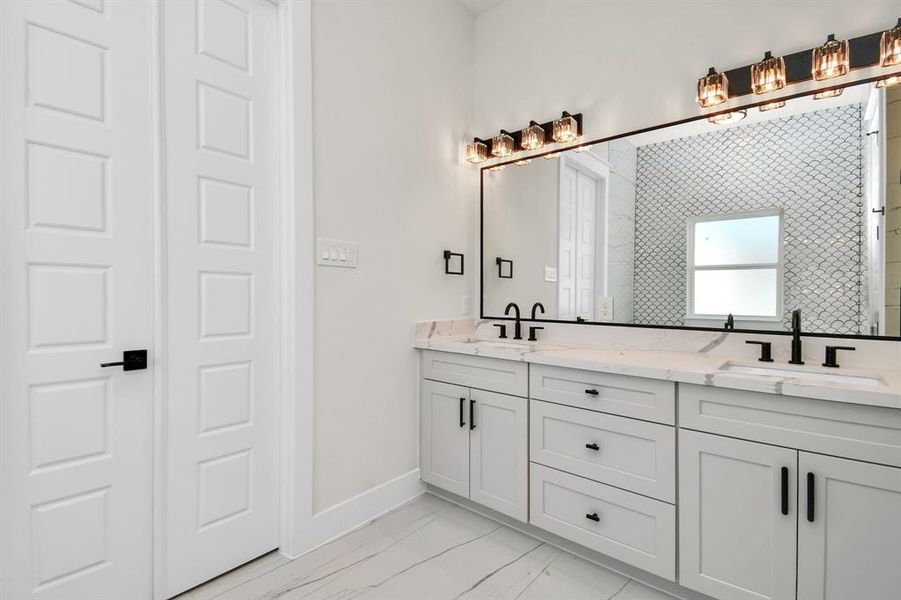 Spa-like bathroom featuring dual vanities, a soaking tub, and a walk-in shower.