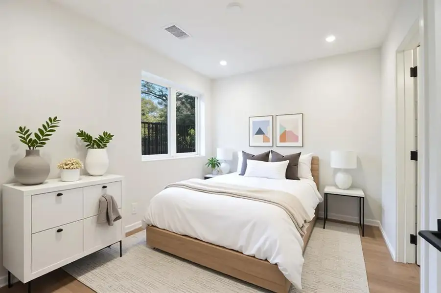 Bedroom with light wood-style flooring and recessed lighting