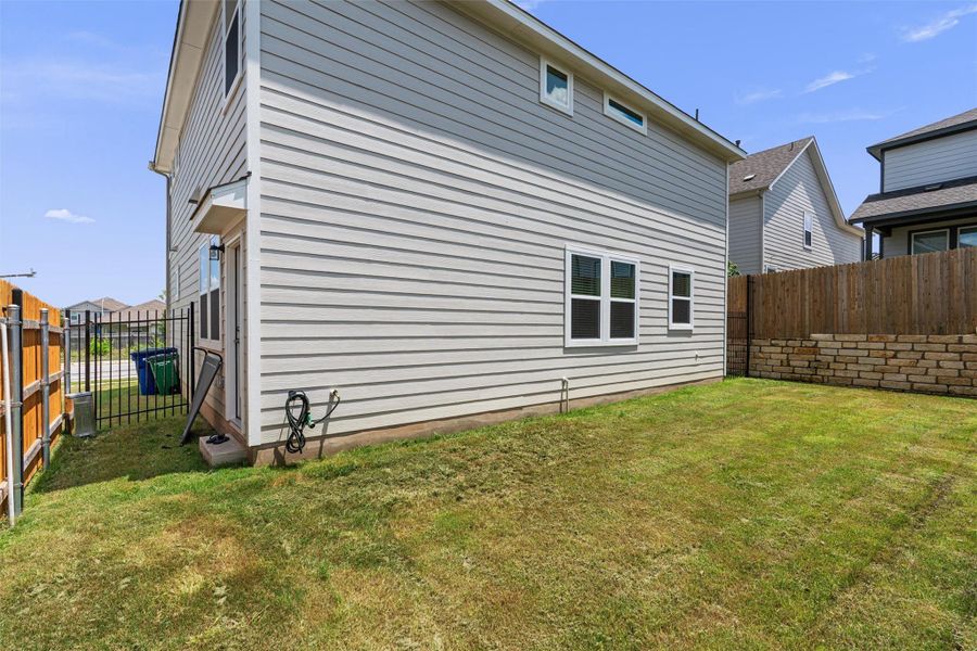 Rear view of property featuring a fenced backyard
