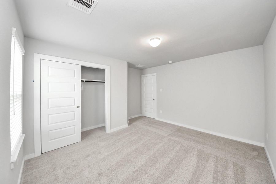 Generously sized secondary bedrooms featuring spacious closets, soft and inviting carpeting underfoot, large windows allowing plenty of natural light, and the added touch of privacy blinds for your personal retreat. Sample photo of completed home with similar floor plan. Actual colors and selections may vary. Generously sized secondary bedrooms featuring spacious closets, soft and inviting carpeting underfoot, large windows allowing plenty of natural light, and the added touch of privacy blinds for your personal retreat. Sample photo of completed home with similar floor plan. Actual colors and selections may vary.