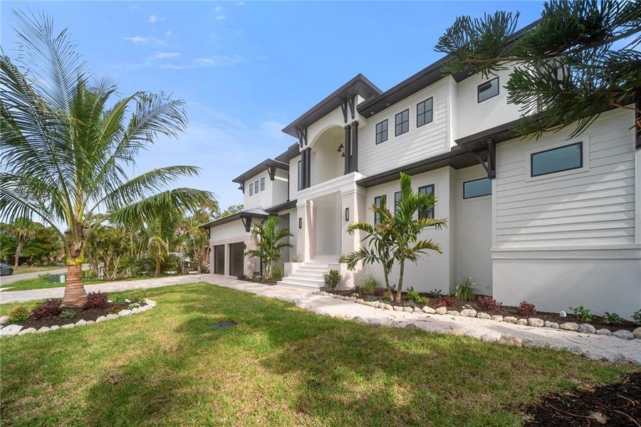 Front exterior of a new home in , Longboat Key, FL, highlighting curb appeal (Image 36). Front exterior of a new home in , Longboat Key, FL, highlighting curb appeal (Image 36).