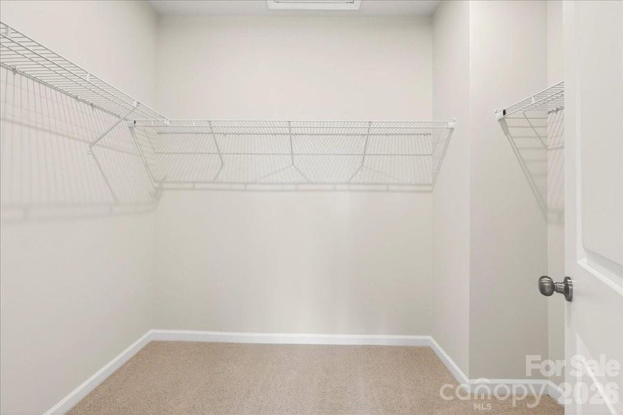 Primary walk-in closet Primary walk-in closet