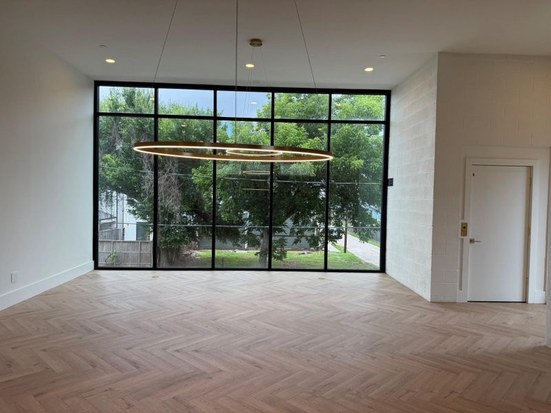 2 nd Floor view from Kitchen looking into the combination Living & Dining Area - note 12 foot ceilings, floor to ceiling striking windows. Upgrades are found throughout the home.