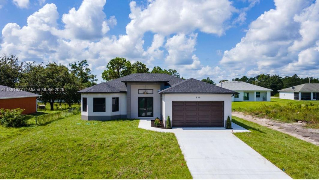 Front exterior of a new home in , Lehigh Acres, FL, highlighting curb appeal (Image 20). Front exterior of a new home in , Lehigh Acres, FL, highlighting curb appeal (Image 20).