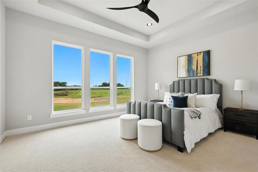 Bedroom featuring light colored carpet, recessed lighting, a tray ceiling, and ceiling fan
