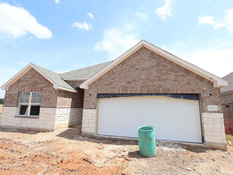Front exterior of a new home in Magnolia Ridge, Magnolia, TX, highlighting curb appeal (Image 14). Front exterior of a new home in Magnolia Ridge, Magnolia, TX, highlighting curb appeal (Image 14).