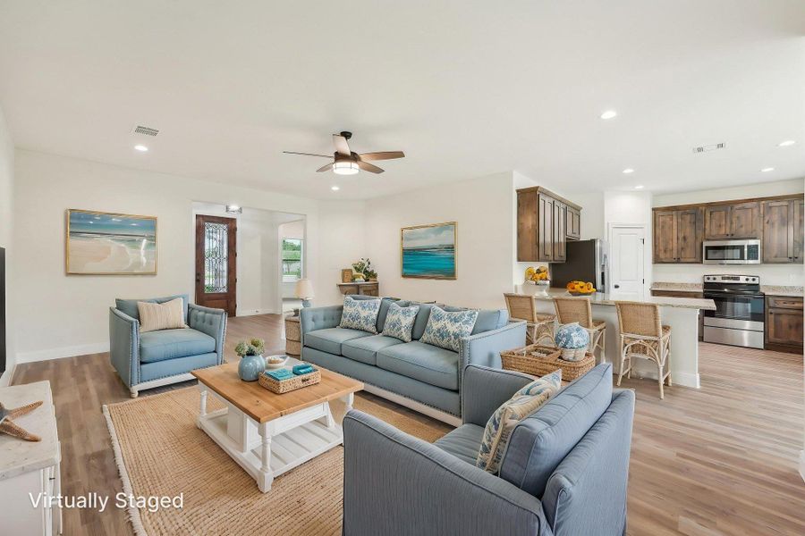 Virtually Staged Living room with Vinyl Wood Plank floor, visible vents, and ceiling fan Virtually Staged Living room with Vinyl Wood Plank floor, visible vents, and ceiling fan