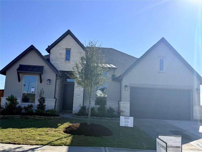 Front exterior of a new home in Pecan Ridge, Fulshear, TX, highlighting curb appeal (Image 2). Front exterior of a new home in Pecan Ridge, Fulshear, TX, highlighting curb appeal (Image 2).