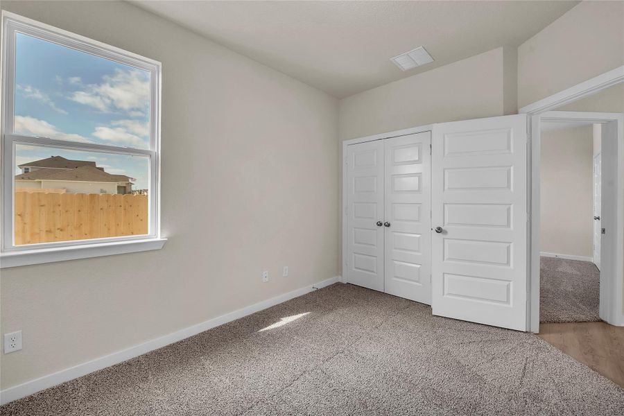 Unfurnished bedroom featuring a closet and light carpet