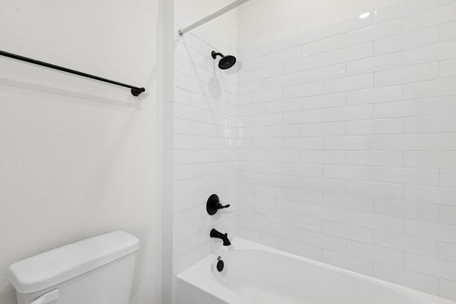 Bathroom featuring  shower combination and toilet
