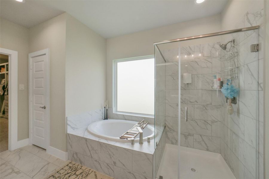 Elegant primary bath with modern finishes throughout.