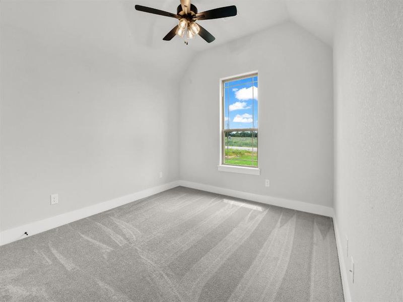 Unfurnished room with light carpet, vaulted ceiling, and ceiling fan