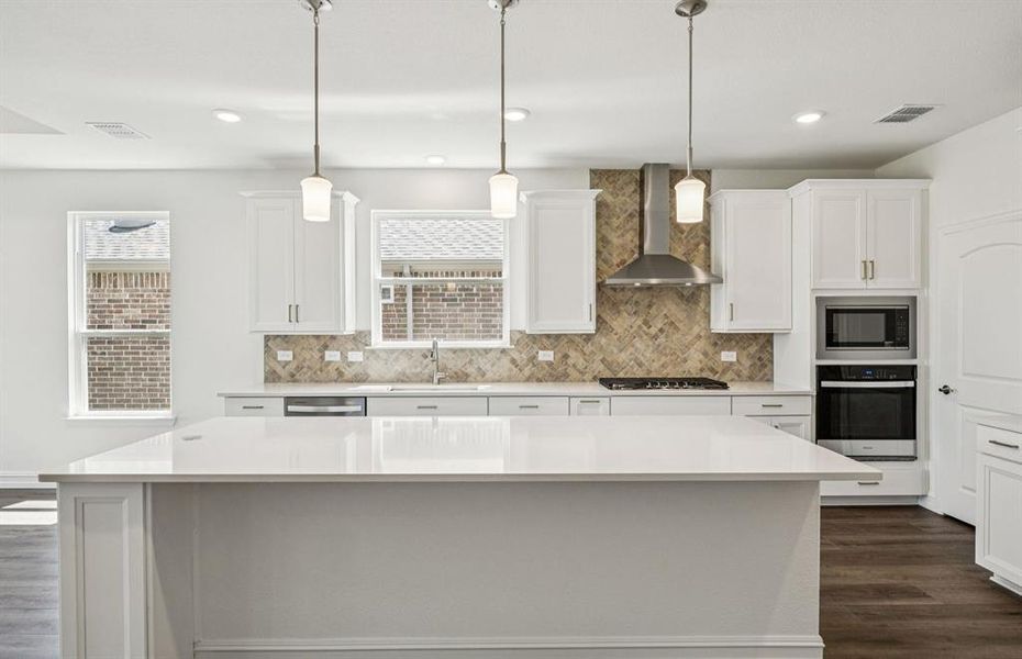 Spacious eat-in kitchen designed with a large island for dining *Real home pictured Spacious eat-in kitchen designed with a large island for dining *Real home pictured