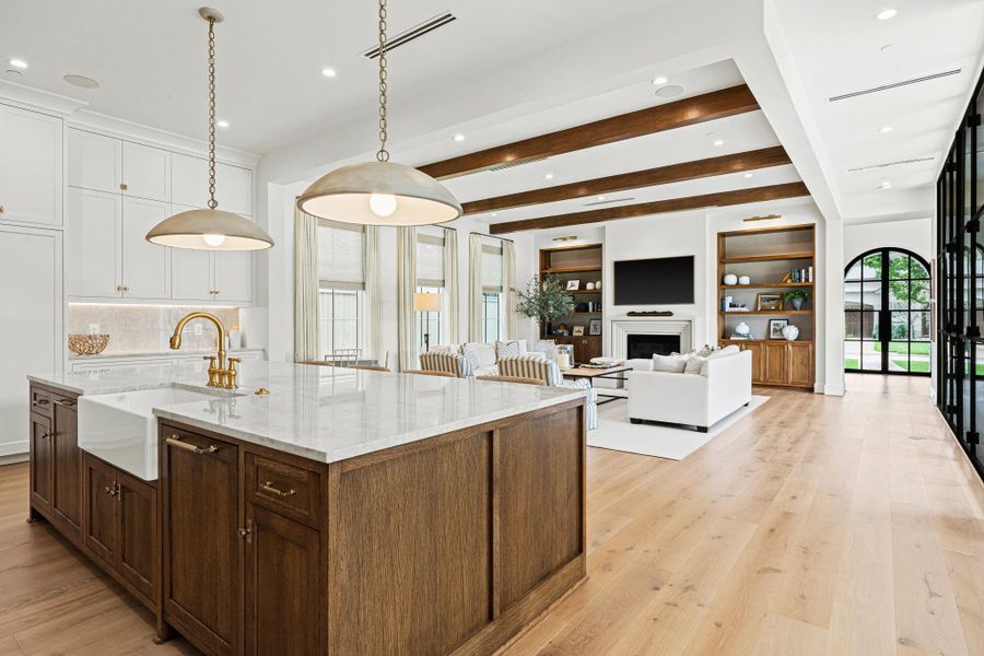 The oversized island with breakfast bar seating serves as the centerpiece of the kitchen, offering generous prep space, breakfast seating & abundant storage. An apron-front sink, pull-out dual trash can storage & soft-close cabinetry add everyday convenience, while the open flow to surrounding living spaces makes it ideal for gathering. The oversized island with breakfast bar seating serves as the centerpiece of the kitchen, offering generous prep space, breakfast seating & abundant storage. An apron-front sink, pull-out dual trash can storage & soft-close cabinetry add everyday convenience, while the open flow to surrounding living spaces makes it ideal for gathering.