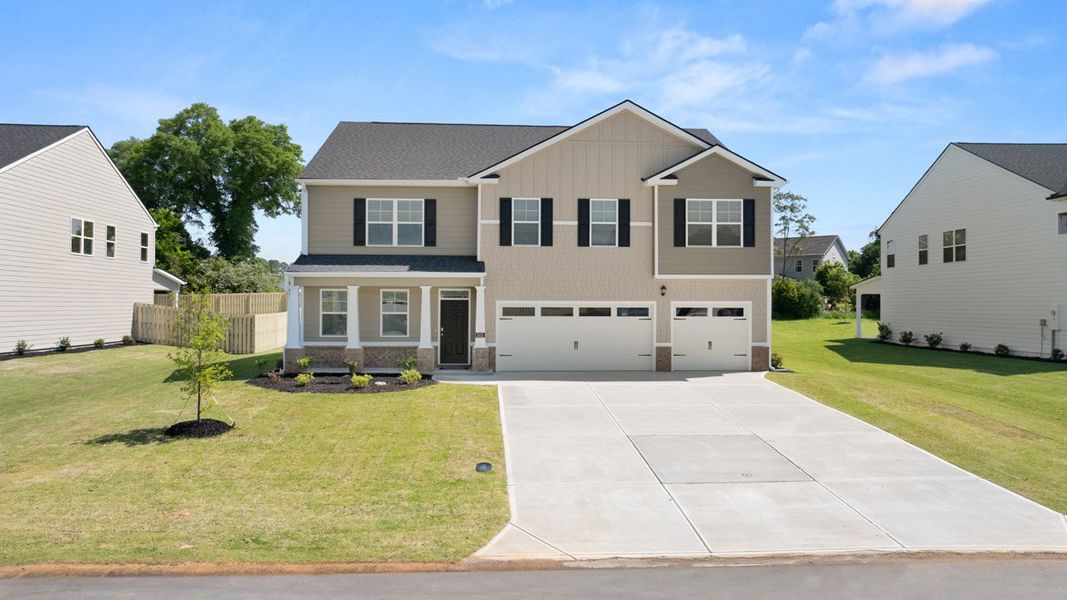 Front exterior of a new home in Southwind Village, Evans, GA, highlighting curb appeal (Image 1).