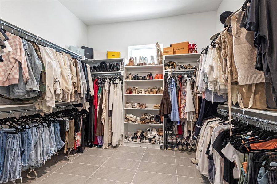 Walk in closet with light tile patterned flooring Walk in closet with light tile patterned flooring