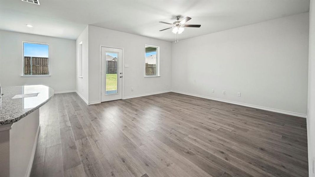 Spacious interior featuring wood-finish flooring, neutral paint, and multiple windows