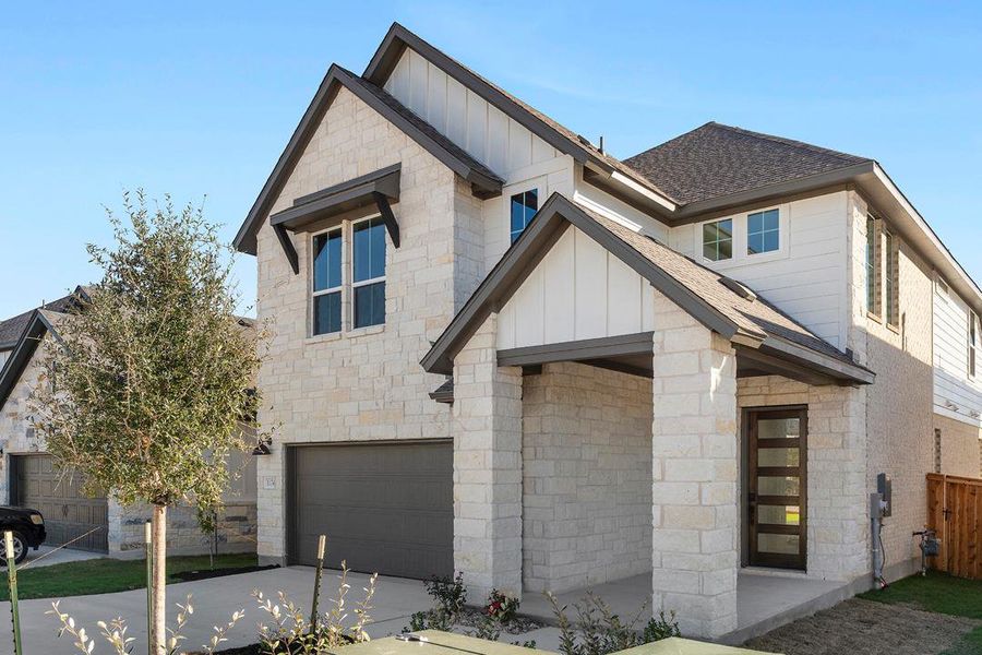Front exterior of a new home in Terrace Collection at Heritage, Dripping Springs, TX, highlighting curb appeal (Image 2). Front exterior of a new home in Terrace Collection at Heritage, Dripping Springs, TX, highlighting curb appeal (Image 2).