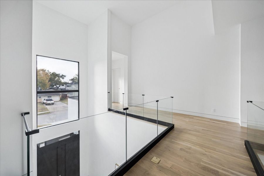 The glass lined walkway is open to both the front entry way and the living room.