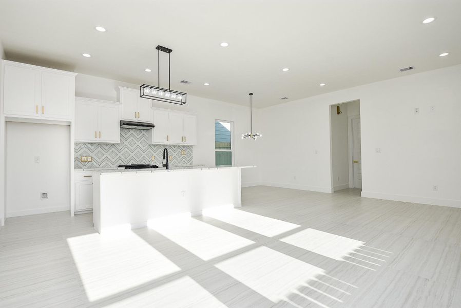 This open-concept kitchen and dining area boasts gleaming luxury laminate floors and abundant natural light from expansive windows. With ample space for any dining setup, it's the perfect blend of elegance and functionality for effortless entertaining. This open-concept kitchen and dining area boasts gleaming luxury laminate floors and abundant natural light from expansive windows. With ample space for any dining setup, it's the perfect blend of elegance and functionality for effortless entertaining.