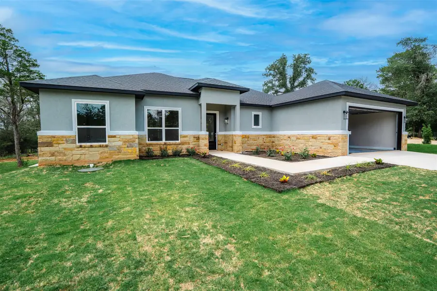 A well-kept lawn and thoughtful landscaping enhance the contemporary stone and stucco facade of this inviting residence. A well-kept lawn and thoughtful landscaping enhance the contemporary stone and stucco facade of this inviting residence.
