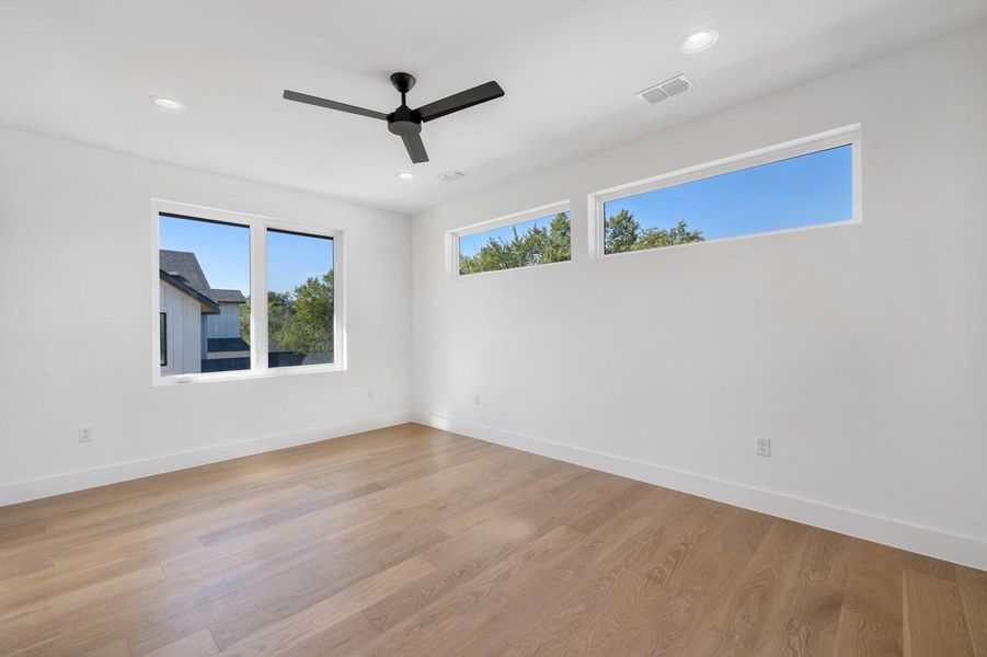 Unfurnished room with light wood finished floors, recessed lighting, and a ceiling fan Unfurnished room with light wood finished floors, recessed lighting, and a ceiling fan