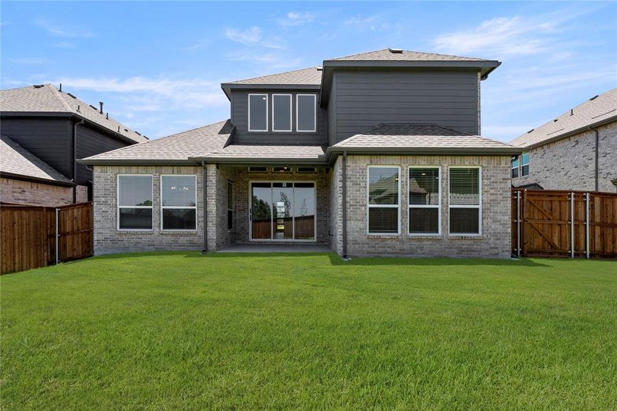 Front exterior of a new home in Spiritas Ranch, Little Elm, TX, highlighting curb appeal (Image 1).
