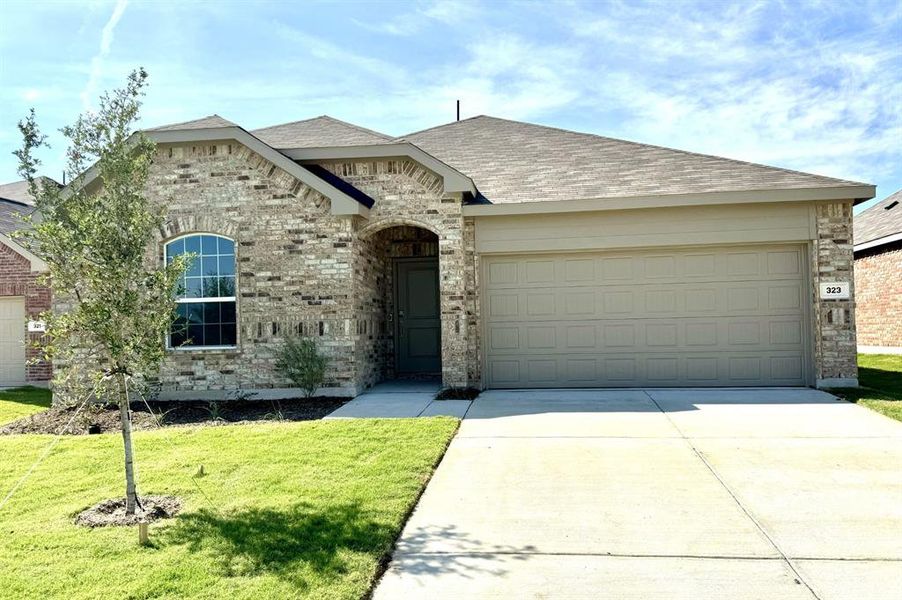 View of front of house with a garage and a front lawn