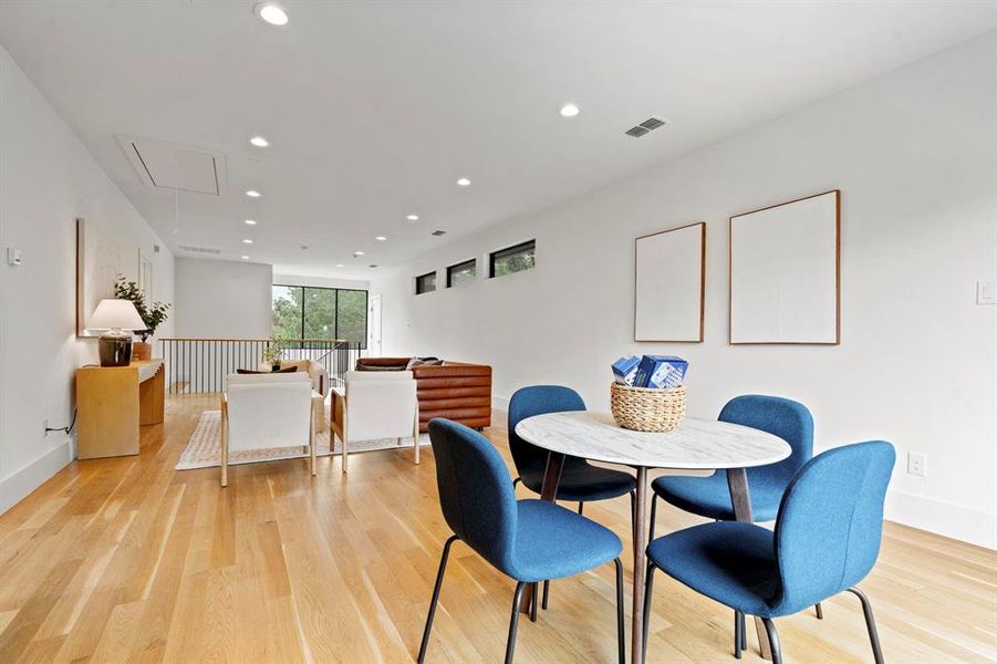 Dining room featuring attic access, recessed lighting, and light wood-style floors Dining room featuring attic access, recessed lighting, and light wood-style floors