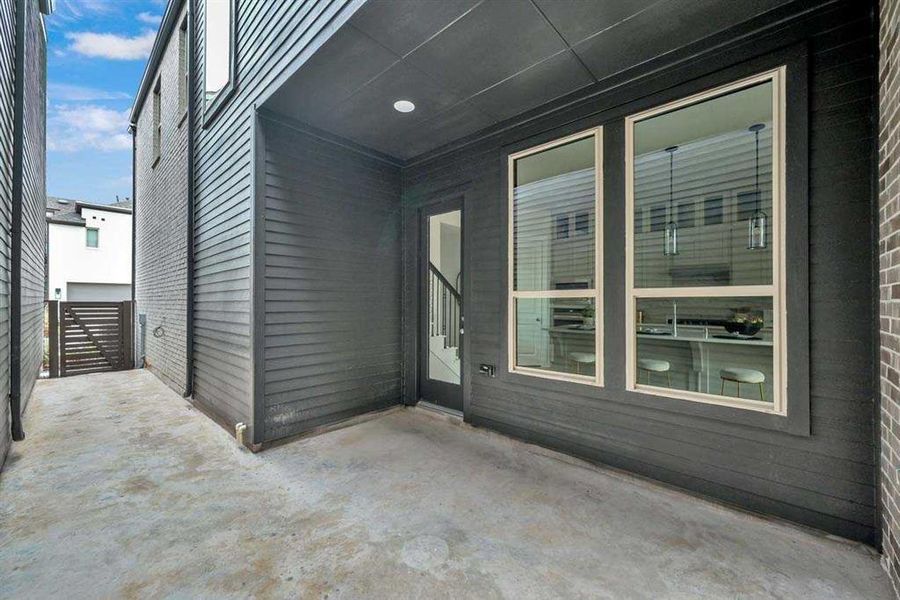 Private covered patio with direct kitchen access for easy indoor-outdoor living. Private side courtyard for grilling, entertaining, or outdoor dining.