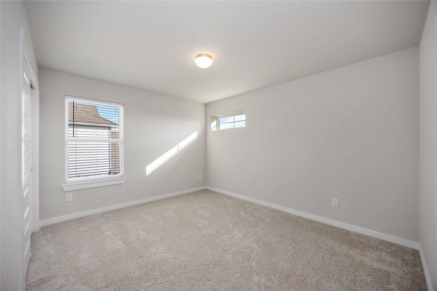 Bright secondary bedroom with soft natural light and generous closet space. Bright secondary bedroom with soft natural light and generous closet space.