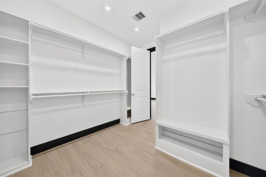 Walk in closet view showcasing abundant shelving and organization options