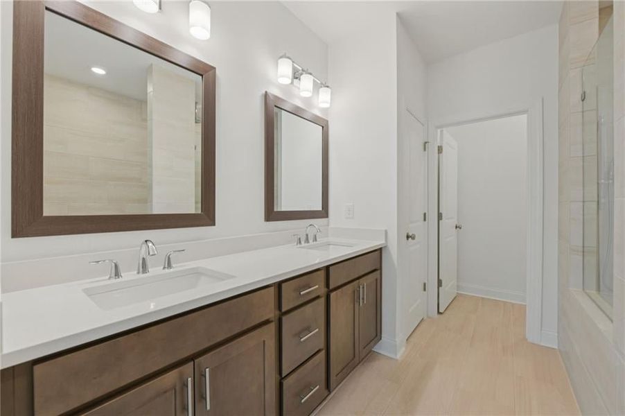 Primary bathroom with separate undermount sinks, and framed mirrors