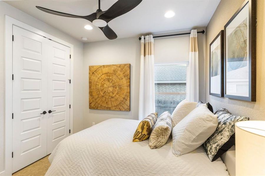 Spacious secondary bedroom features a generous closet and ensuite bath.