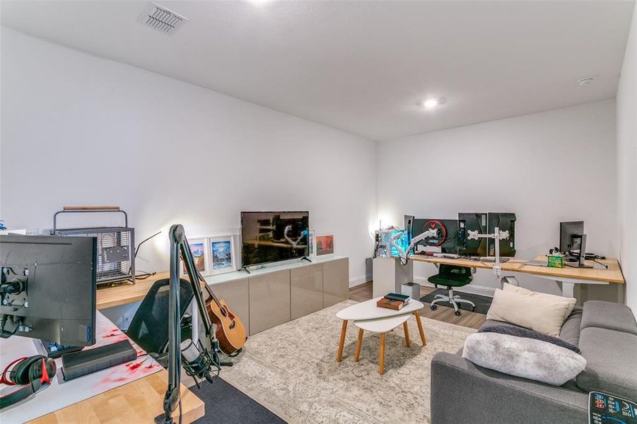Office space with wood finished floors and recessed lighting