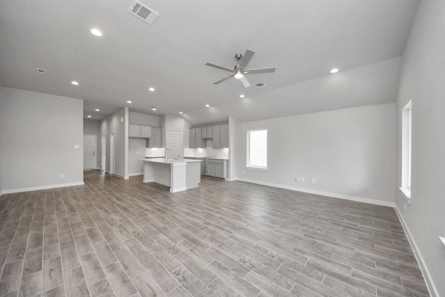 Gather the family and guests together in your lovely living room! Featuring soaring high ceilings, recessed lighting, ceiling fan, custom paint, gorgeous floors, and large windows that provide plenty of natural lighting throughout the day. Sample photo of completed home with similar floor plan. Actual colors and selections may vary. Gather the family and guests together in your lovely living room! Featuring soaring high ceilings, recessed lighting, ceiling fan, custom paint, gorgeous floors, and large windows that provide plenty of natural lighting throughout the day. Sample photo of completed home with similar floor plan. Actual colors and selections may vary.