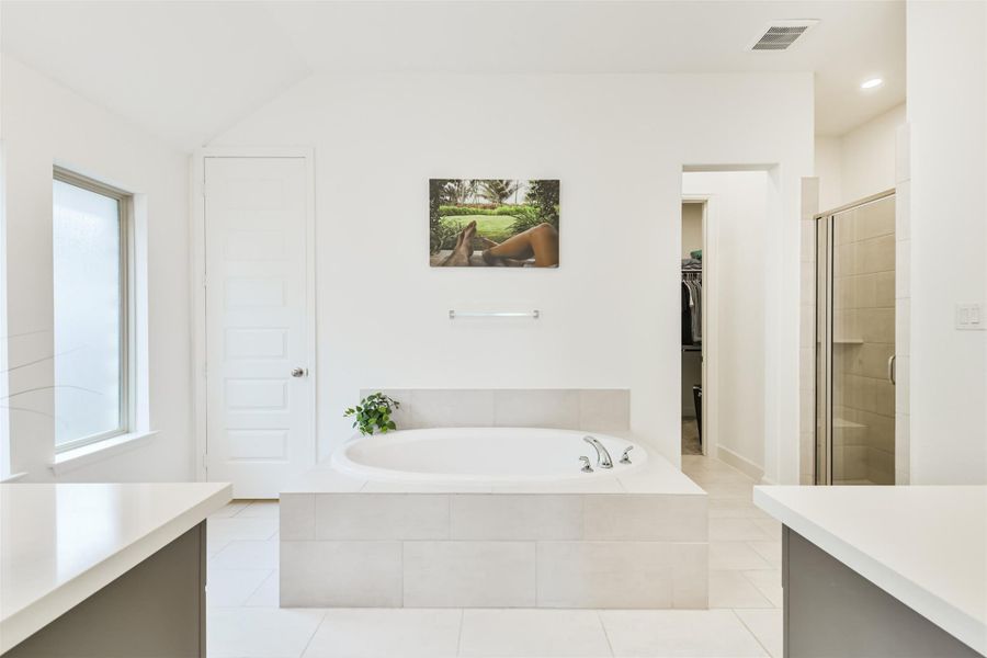 Primary bath boasts a large soaking tub, separate shower, double sinks, and double walk-in closets. Primary bath boasts a large soaking tub, separate shower, double sinks, and double walk-in closets.