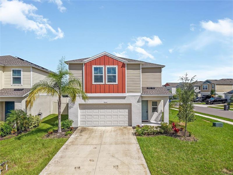 Front exterior of a new home in Crosswind Point, Parrish, FL, highlighting curb appeal (Image 2). Front exterior of a new home in Crosswind Point, Parrish, FL, highlighting curb appeal (Image 2).