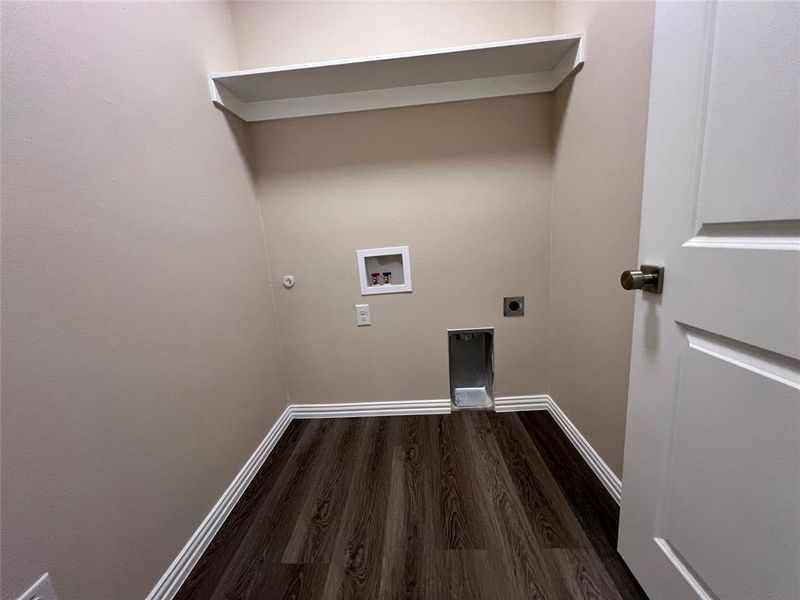 Washroom featuring hookup for an electric dryer, hookup for a washing machine, dark hardwood / wood-style floors, and gas dryer hookup