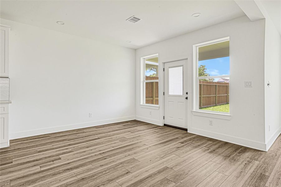 Bright dining space with natural light and views of the backyard. Bright dining space with natural light and views of the backyard.