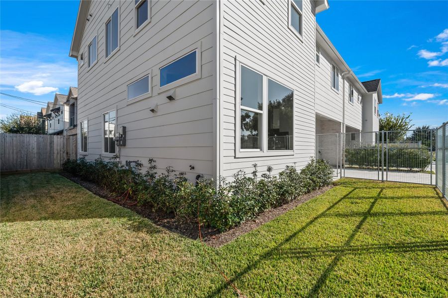 Privately gated front yard with full gutters & French drains, rare features in new construction plus a side yard that leads to the backyard for added convenience.