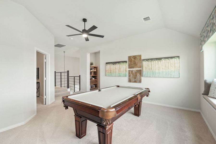 Game room with wood pool table, ceiling fan, carpet floors, and open staircase railing nearby