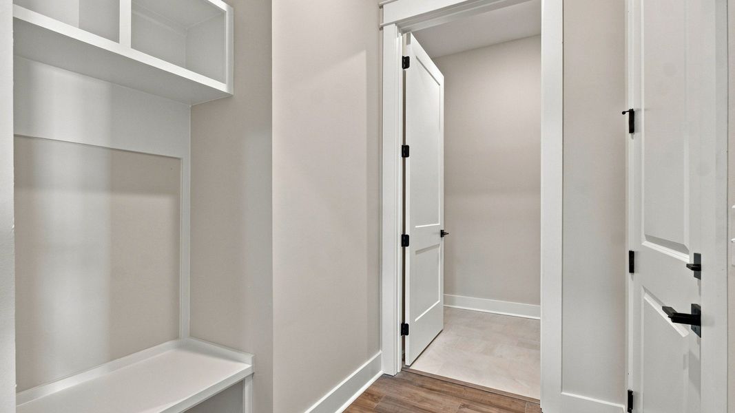 MDF built and painted drop zone bench and cubbies near garage entry for your convenience