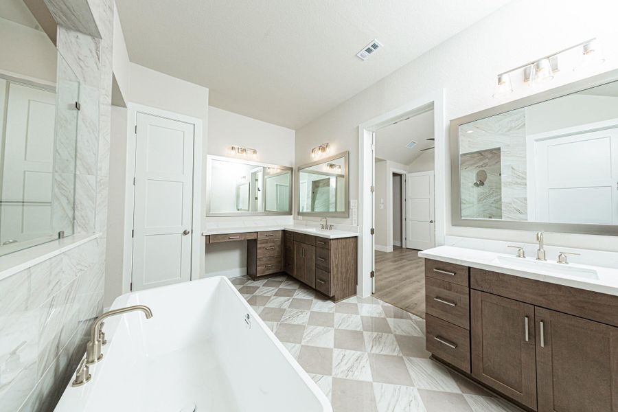 Additional view of dual vanities which also includes another vanity with knee space, allowing for a comfortable, seated grooming experience. Additional view of dual vanities which also includes another vanity with knee space, allowing for a comfortable, seated grooming experience.