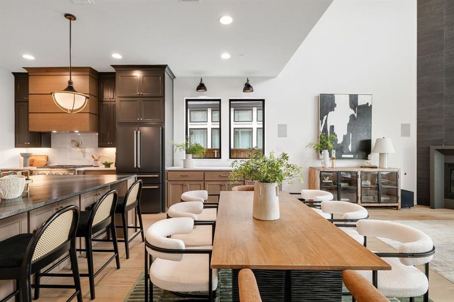 Dining area featuring recessed lighting, a fireplace, and light wood finished floors Dining area featuring recessed lighting, a fireplace, and light wood finished floors
