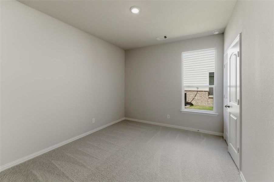 Unfurnished room with light colored carpet and baseboards